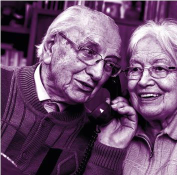 Smiling couple listen to handset